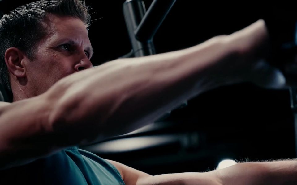Athlete driving a cable press