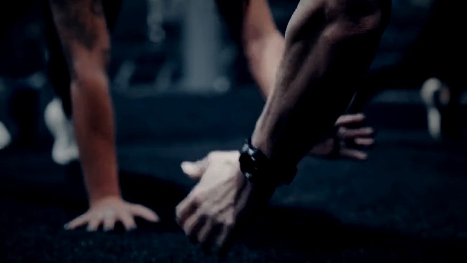 Hands on the turf for a bodyweight strength hold