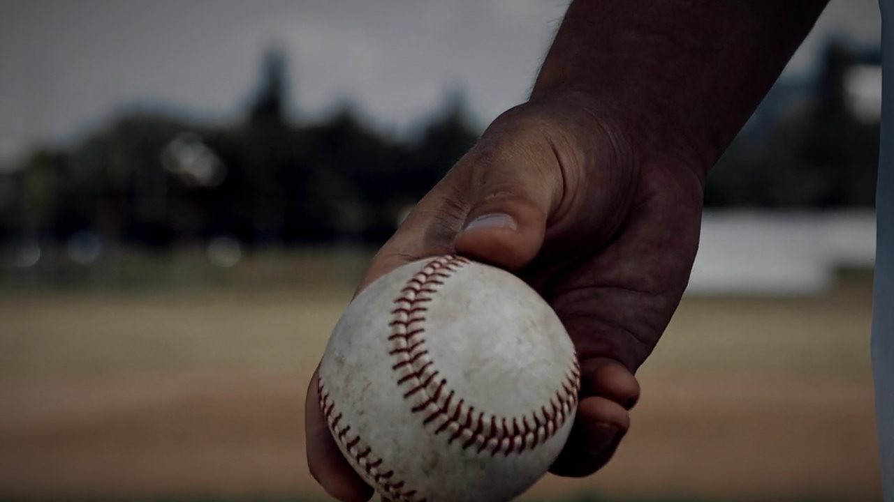 Close up of a hand gripping a ball